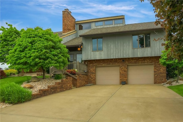 199 Rustic Dr, North Huntingdon, PA 15642 - view of front of property featuring a garage, concrete driveway, roof with shingles, and brick siding