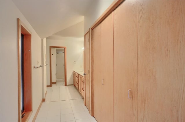 199 Rustic Dr, North Huntingdon, PA 15642 - hall featuring light tile patterned floors, baseboards, and vaulted ceiling