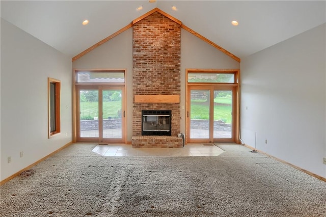 199 Rustic Dr, North Huntingdon, PA 15642 - unfurnished living room featuring high vaulted ceiling, carpet floors, a brick fireplace, baseboards, and recessed lighting