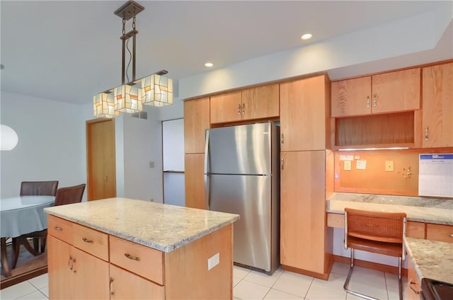 199 Rustic Dr, North Huntingdon, PA 15642 - kitchen with freestanding refrigerator, light brown cabinetry, a center island, light stone countertops, and recessed lighting