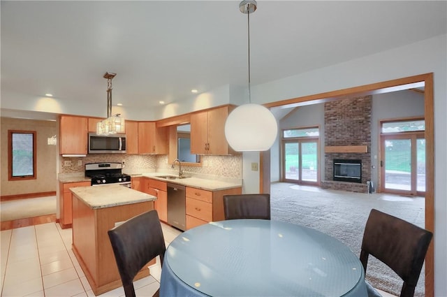 199 Rustic Dr, North Huntingdon, PA 15642 - kitchen with appliances with stainless steel finishes, a sink, light countertops, backsplash, and a center island