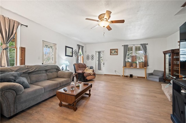 104 Overholt Dr, Scottdale, PA 15683 - living area with wood finished floors, a ceiling fan, and a textured ceiling
