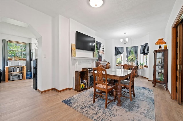 104 Overholt Dr, Scottdale, PA 15683 - dining space featuring light wood-style flooring, baseboards, a chandelier, and cooling unit