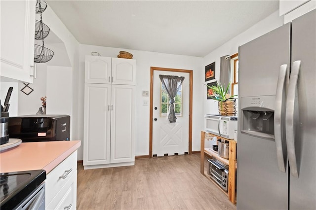 104 Overholt Dr, Scottdale, PA 15683 - kitchen featuring stainless steel fridge, white microwave, white cabinetry, and light wood-style flooring
