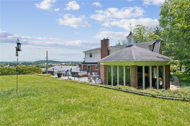 1199 Chestnut St, Indiana Boro Ind, PA 15701 - rear view of house featuring a patio, a lawn, brick siding, and a shingled roof