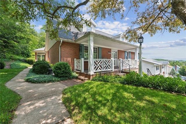 1199 Chestnut St, Indiana Boro Ind, PA 15701 - view of front of home featuring a porch, brick siding, a chimney, and a front lawn