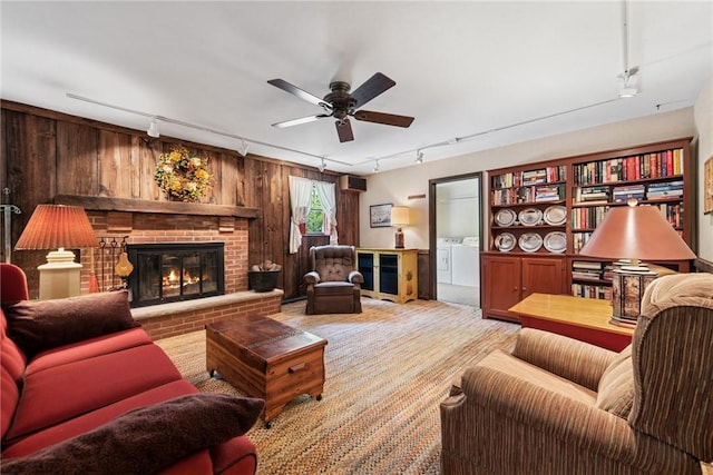 1199 Chestnut St, Indiana Boro Ind, PA 15701 - carpeted living room featuring track lighting, washer and dryer, a fireplace, a ceiling fan, and wood walls