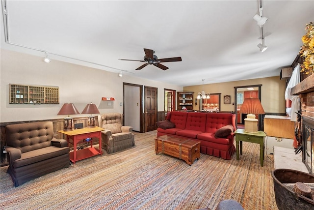 1199 Chestnut St, Indiana Boro Ind, PA 15701 - carpeted living room featuring rail lighting, a ceiling fan, a fireplace, and a chandelier