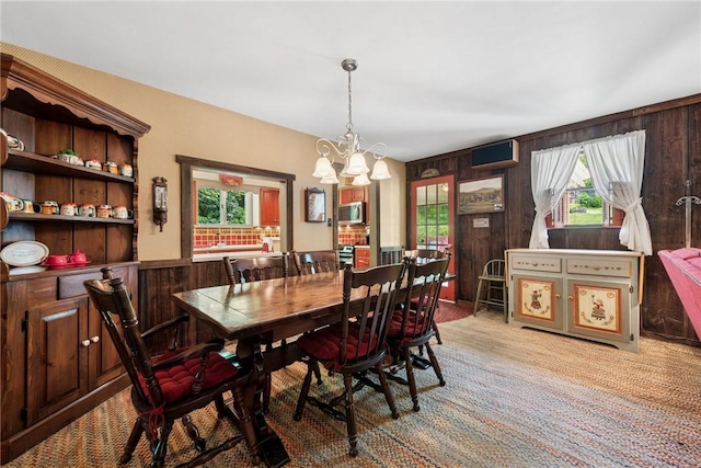 1199 Chestnut St, Indiana Boro Ind, PA 15701 - dining area with a chandelier, light colored carpet, and wood walls