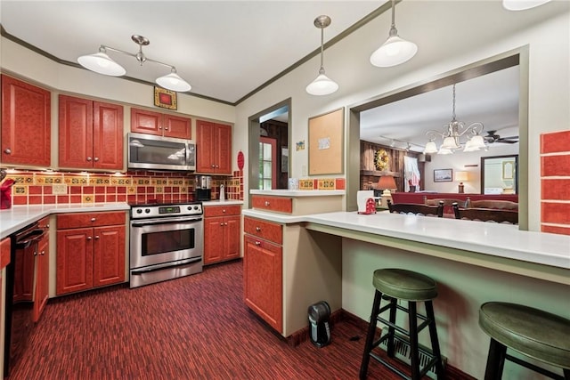 1199 Chestnut St, Indiana Boro Ind, PA 15701 - kitchen featuring stainless steel appliances, light countertops, a kitchen bar, backsplash, and decorative light fixtures
