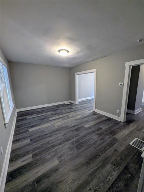1217 Scott St, Mckeesport, PA 15132 - unfurnished room with dark wood-style flooring, baseboards, and a smoke detector