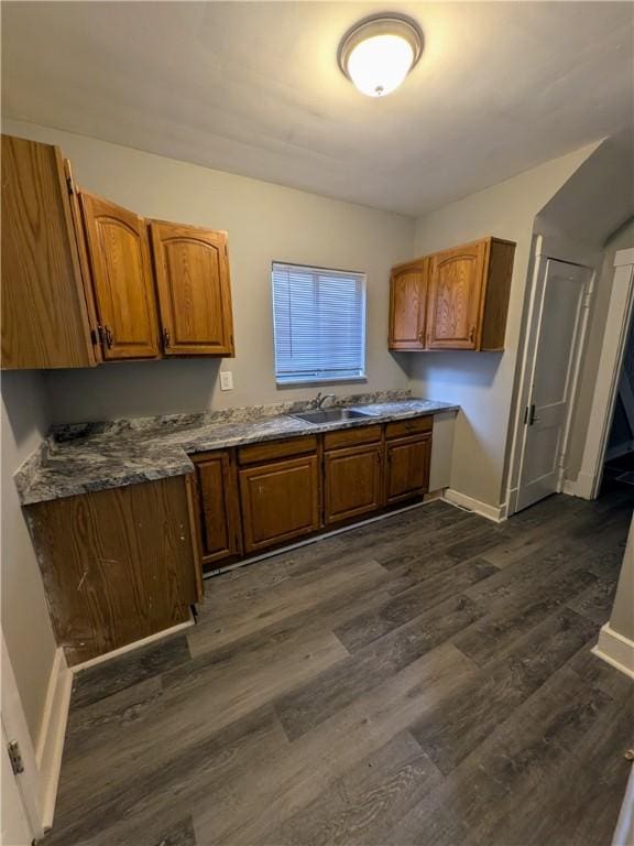 1217 Scott St, Mckeesport, PA 15132 - kitchen with baseboards, brown cabinets, and dark wood-type flooring