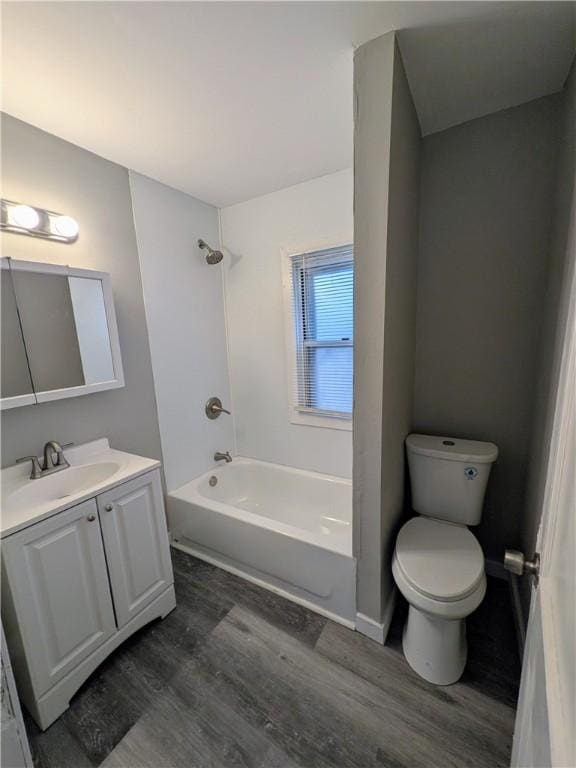 1217 Scott St, Mckeesport, PA 15132 - full bath with wood finished floors, toilet, vanity, and bathing tub / shower combination