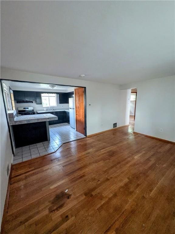 1105 Parkside Dr, Rear Brackenridge, PA 15014 - unfurnished living room featuring light wood finished floors and baseboards