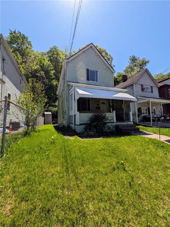 518 Glenn St, Wilmerding, PA 15148 - back of property with a yard and covered porch
