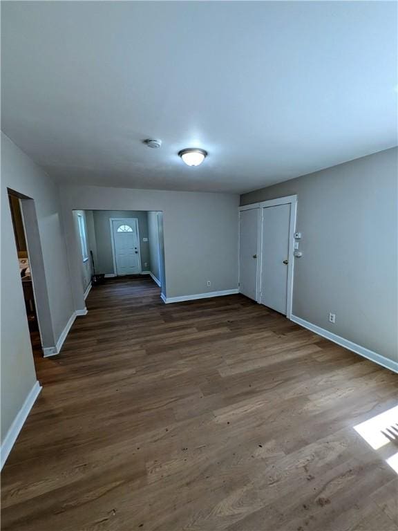 518 Glenn St, Wilmerding, PA 15148 - unfurnished living room featuring baseboards and dark wood-type flooring