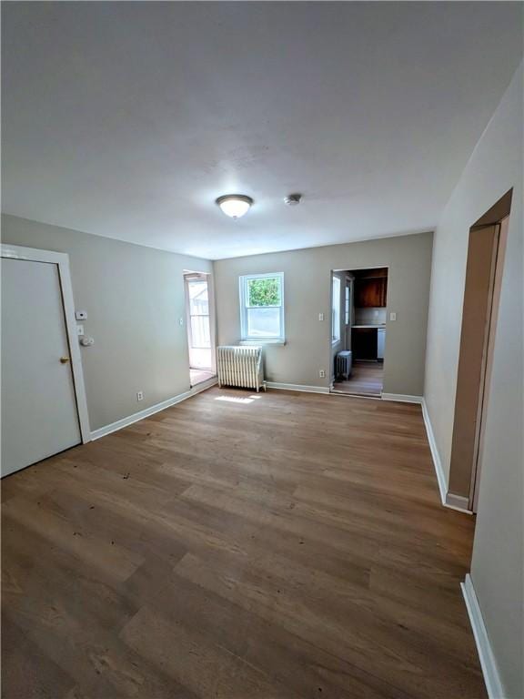518 Glenn St, Wilmerding, PA 15148 - spare room featuring radiator heating unit, wood finished floors, and baseboards