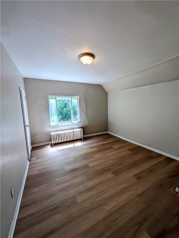 518 Glenn St, Wilmerding, PA 15148 - additional living space with radiator, baseboards, vaulted ceiling, and wood finished floors