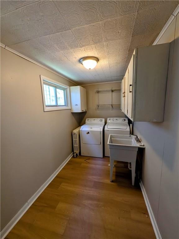 518 Glenn St, Wilmerding, PA 15148 - laundry area with washer and dryer, radiator, baseboards, light wood-style flooring, and an ornate ceiling