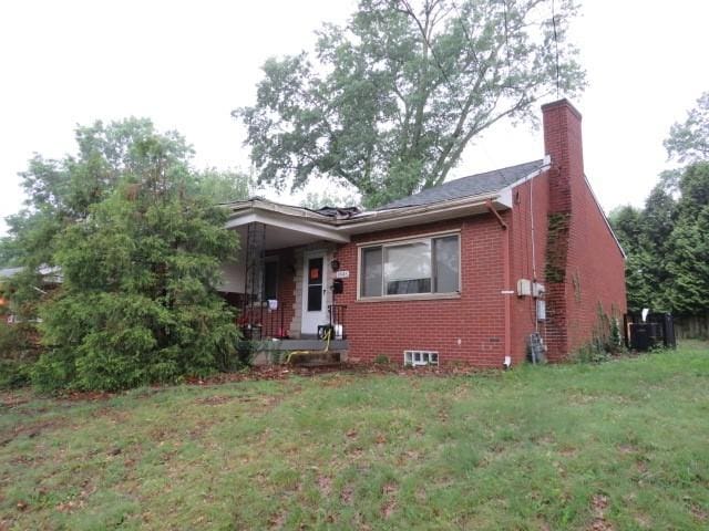 1845 Atkinson Pl, Wilkinsburg, PA 15235 - bungalow-style house featuring brick siding, a front lawn, a chimney, and a porch