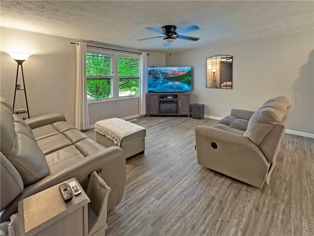 108 Bucks Rd, Cranberry Twp, PA 16066 - living area with ceiling fan, wood finished floors, baseboards, and a textured ceiling