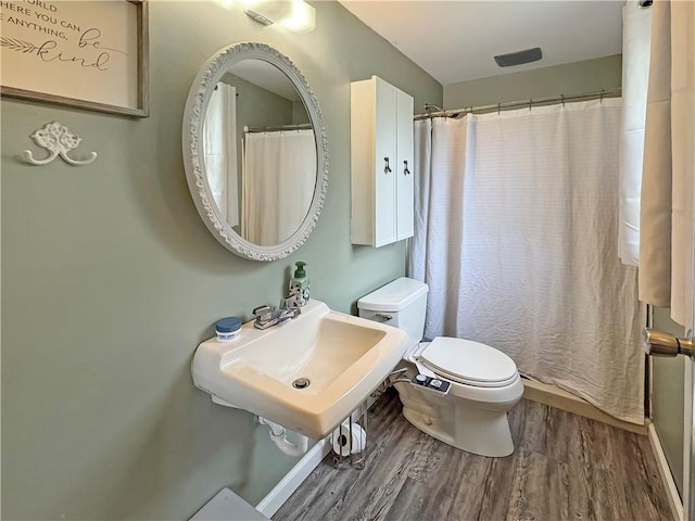 108 Bucks Rd, Cranberry Twp, PA 16066 - bathroom with wood finished floors, toilet, a sink, and a shower with shower curtain