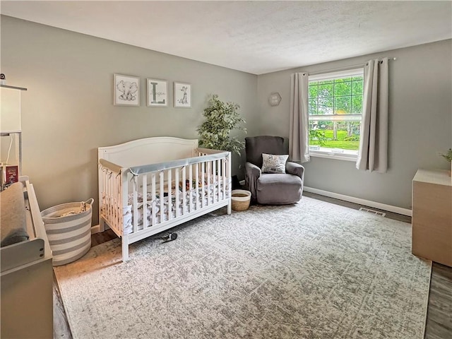 108 Bucks Rd, Cranberry Twp, PA 16066 - bedroom with wood finished floors, a crib, and baseboards