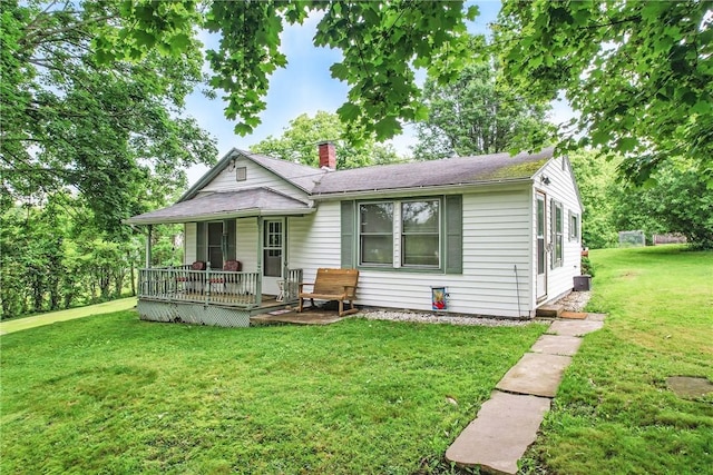 283 S 5th St, Sharpsville, PA 16150 - rear view of house with a porch, a yard, a chimney, and roof with shingles