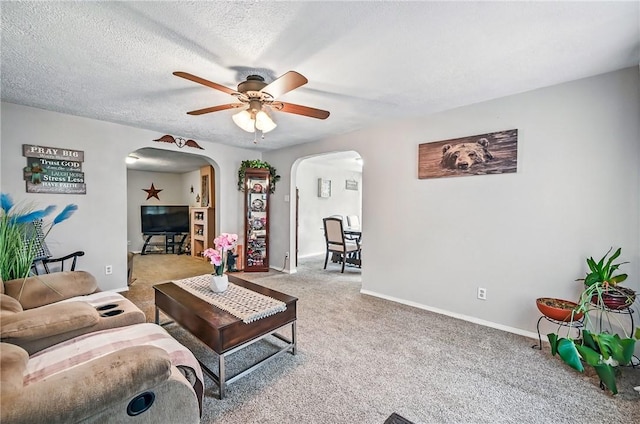 283 S 5th St, Sharpsville, PA 16150 - carpeted living room featuring arched walkways, a ceiling fan, and baseboards