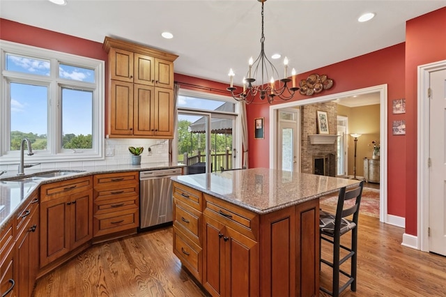 112 Beaver Creek Ct, Sewickley, PA 15143 - kitchen with stainless steel dishwasher, a sink, a kitchen bar, recessed lighting, and a chandelier