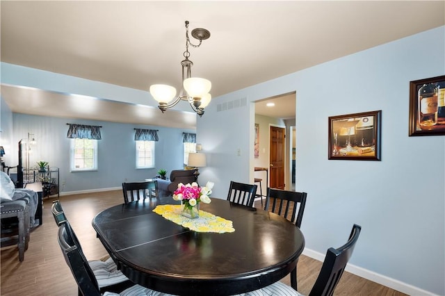 2609 Fox Chase Ct, South Fayette, PA 15017 - dining area featuring wood finished floors, a chandelier, and baseboards