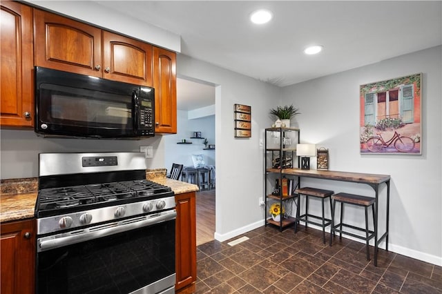 2609 Fox Chase Ct, South Fayette, PA 15017 - kitchen featuring stainless steel gas range, black microwave, baseboards, recessed lighting, and brown cabinetry