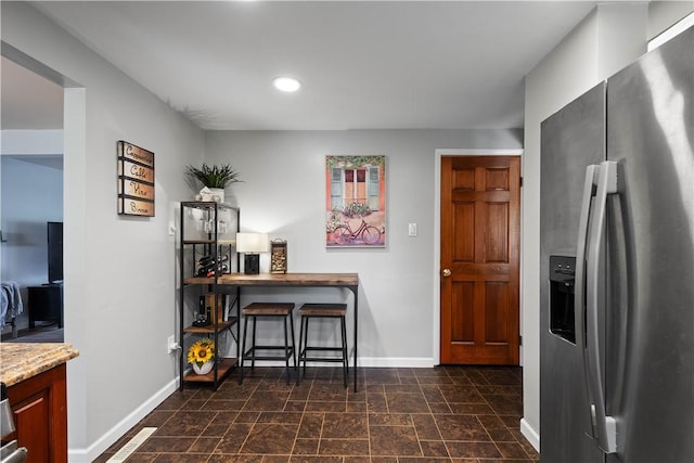 2609 Fox Chase Ct, South Fayette, PA 15017 - kitchen featuring stainless steel refrigerator with ice dispenser, baseboards, recessed lighting, dark stone finish floors, and light stone counters