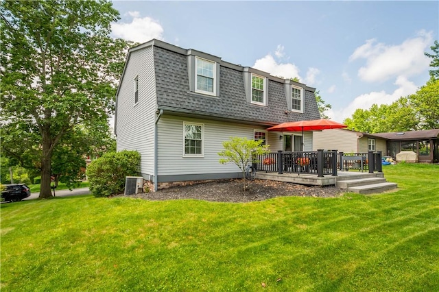 2609 Fox Chase Ct, South Fayette, PA 15017 - back of house featuring roof with shingles, a deck, a lawn, a gambrel roof, and central AC