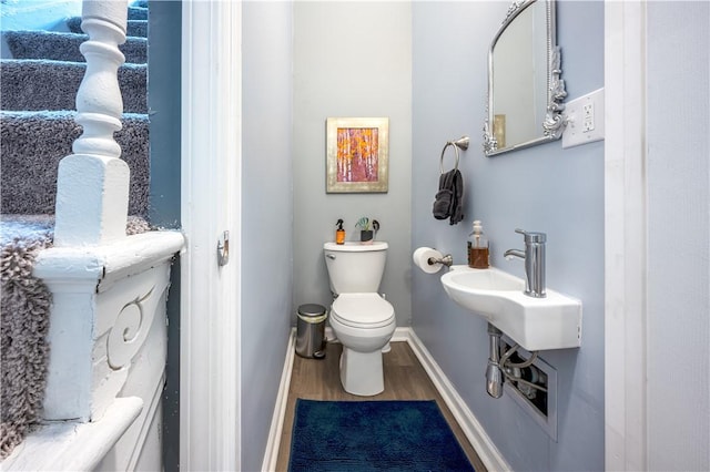 1701 Meadville St, Fineview, PA 15214 - half bathroom featuring wood finished floors, toilet, baseboards, and a sink