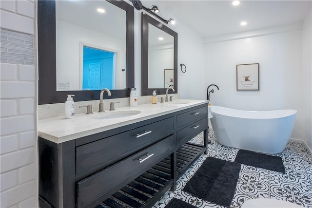1701 Meadville St, Fineview, PA 15214 - bathroom featuring double vanity, a freestanding bath, recessed lighting, and tile patterned floors
