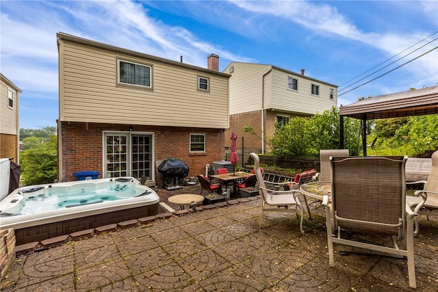 2920 Roland Ave, Baldwin Boro, PA 15227 - rear view of house with an outdoor hot tub, a patio area, outdoor dining area, and brick siding