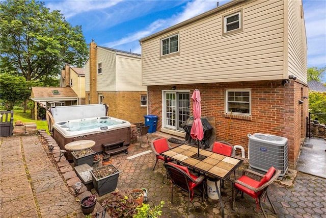 2920 Roland Ave, Baldwin Boro, PA 15227 - back of house with a hot tub, cooling unit, a patio area, brick siding, and outdoor dining area