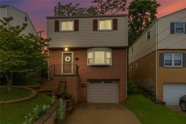2920 Roland Ave, Baldwin Boro, PA 15227 - colonial inspired home featuring an attached garage, brick siding, a front lawn, and driveway