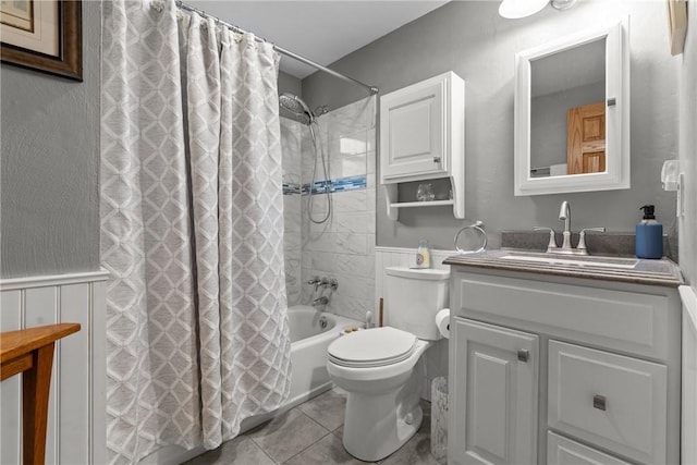 2920 Roland Ave, Baldwin Boro, PA 15227 - full bath with vanity, shower / bathtub combination with curtain, wainscoting, toilet, and tile patterned flooring