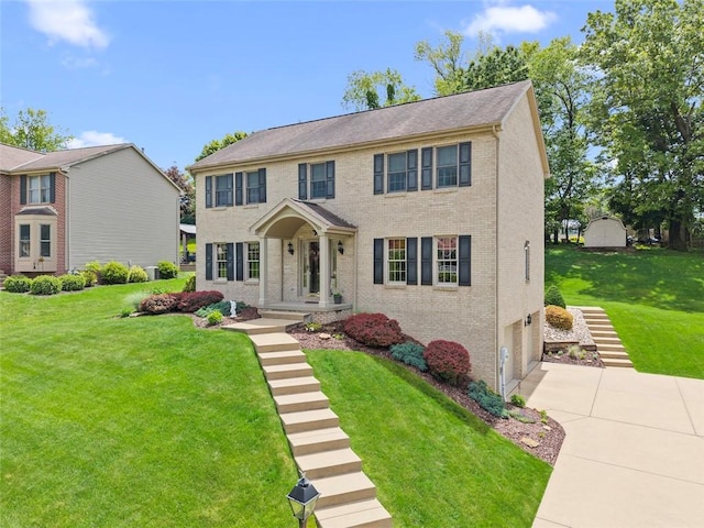 1408 Fernledge Dr, Shaler, PA 15101 - colonial home featuring concrete driveway, a garage, a front lawn, and brick siding