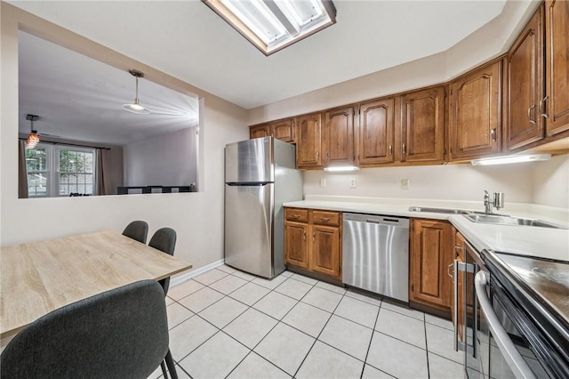 4677 Bayard St Unit 201, Oakland, PA 15213 - kitchen featuring appliances with stainless steel finishes, brown cabinets, light countertops, and light tile patterned floors