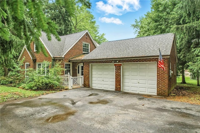1060 S Hermitage Rd, Hermitage, PA 16148 - view of front facade with roof with shingles, brick siding, and a garage