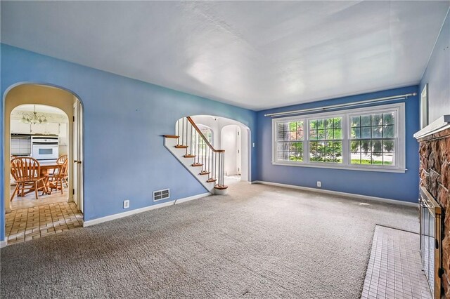1060 S Hermitage Rd, Hermitage, PA 16148 - unfurnished living room with arched walkways, carpet flooring, stairway, and baseboards