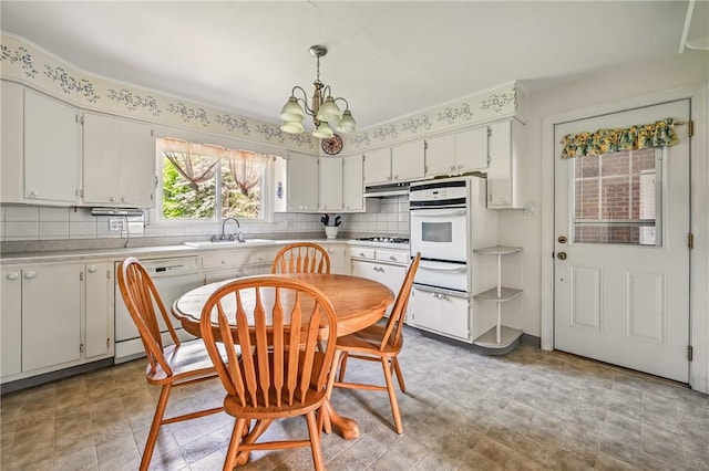 1060 S Hermitage Rd, Hermitage, PA 16148 - kitchen featuring white appliances, a sink, a warming drawer, a chandelier, and light countertops