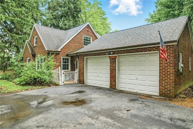 1060 S Hermitage Rd, Hermitage, PA 16148 - view of front of property with roof with shingles, brick siding, an attached garage, a gate, and asphalt driveway