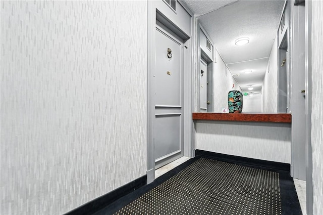 5048 5th Ave Unit 101, Shadyside, PA 15232 - corridor featuring baseboards, a textured ceiling, and carpet
