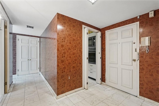 5048 5th Ave Unit 101, Shadyside, PA 15232 - corridor with light marble finish flooring, wallpapered walls, and baseboards