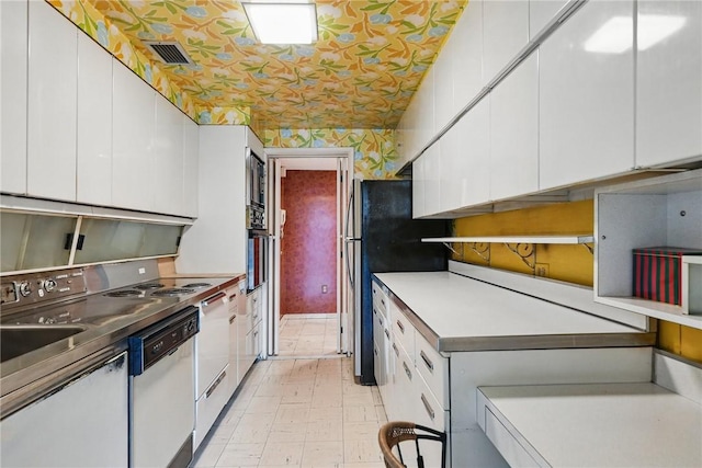 5048 5th Ave Unit 101, Shadyside, PA 15232 - kitchen with dishwasher, white cabinetry, light countertops, freestanding refrigerator, and light floors