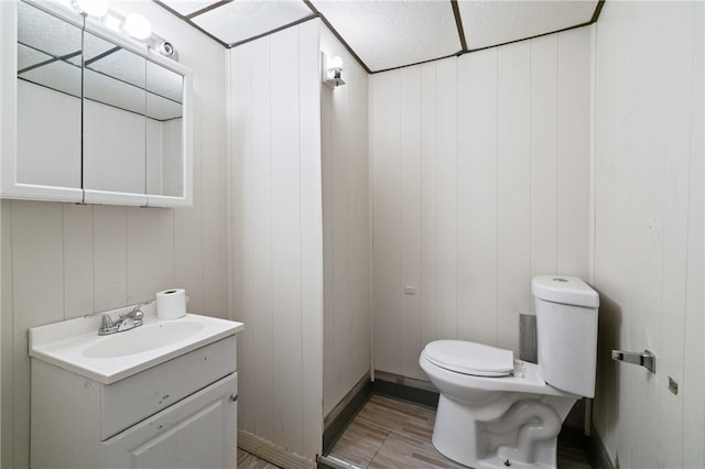 1332 Diana St, Troy Hill, PA 15212 - half bathroom featuring toilet, vanity, and wood finished floors